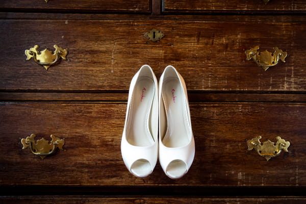 Brides shoes hanging from drawers