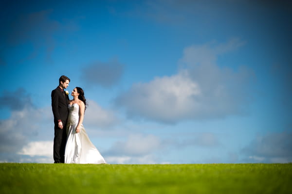 Bride and groom on top of hill