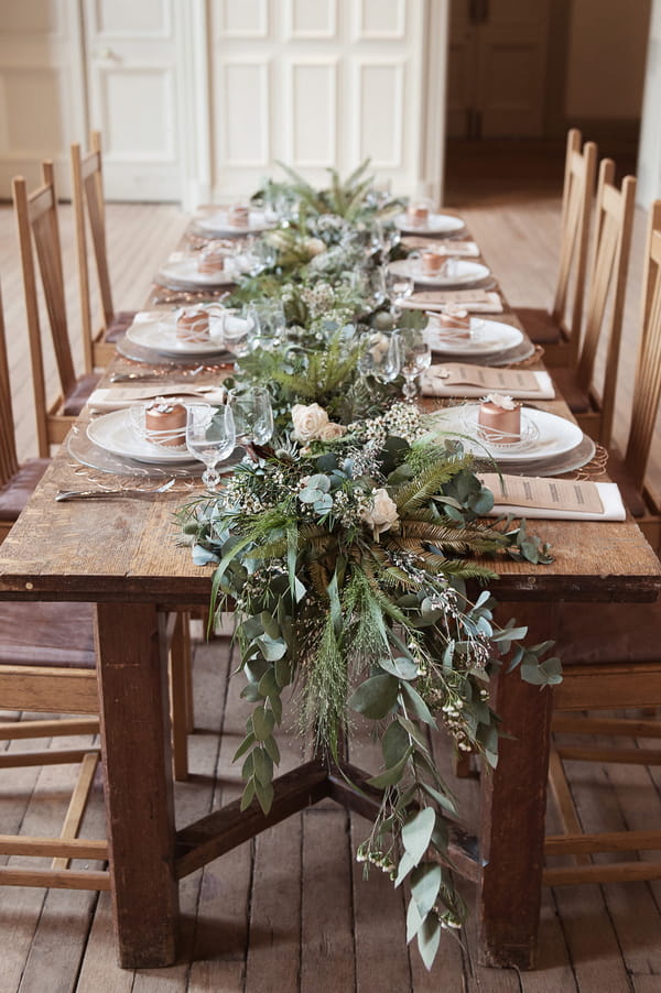 Wedding table with large foliage centrepiece