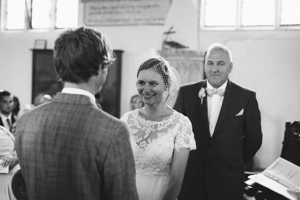 Bride and groom facing each other in church