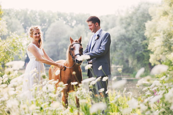 Bride and groom with pony