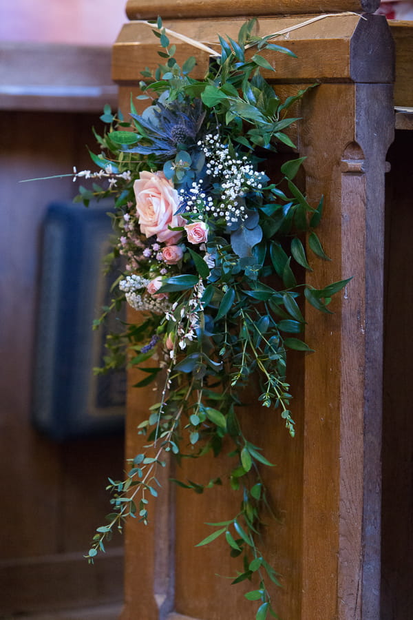 Flowers on end of church pew
