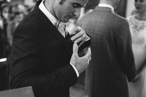 Best man taking wedding rings out of pocket