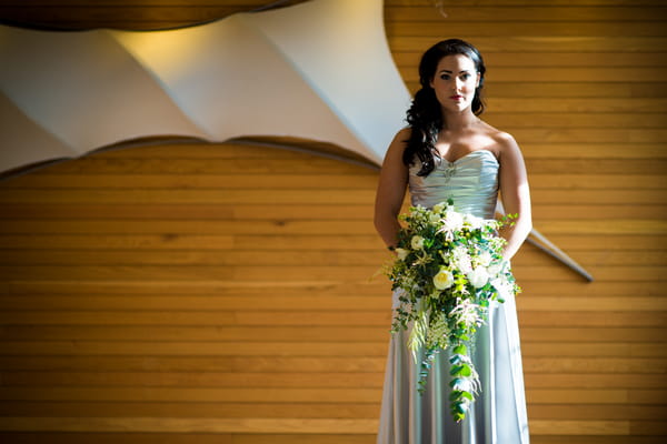 Bride holding cascading bouquet