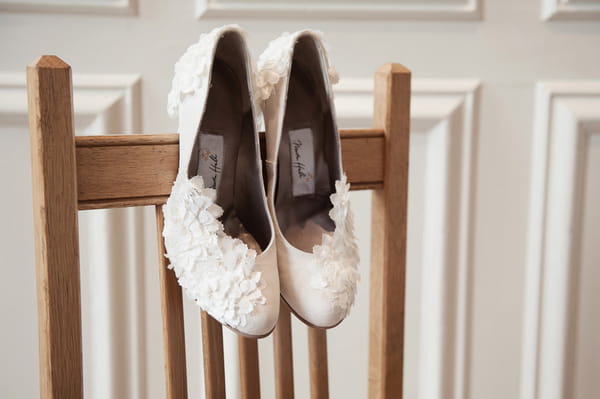 Wedding shoes on back of chair