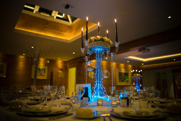 Large table candelabra lit up with blue light