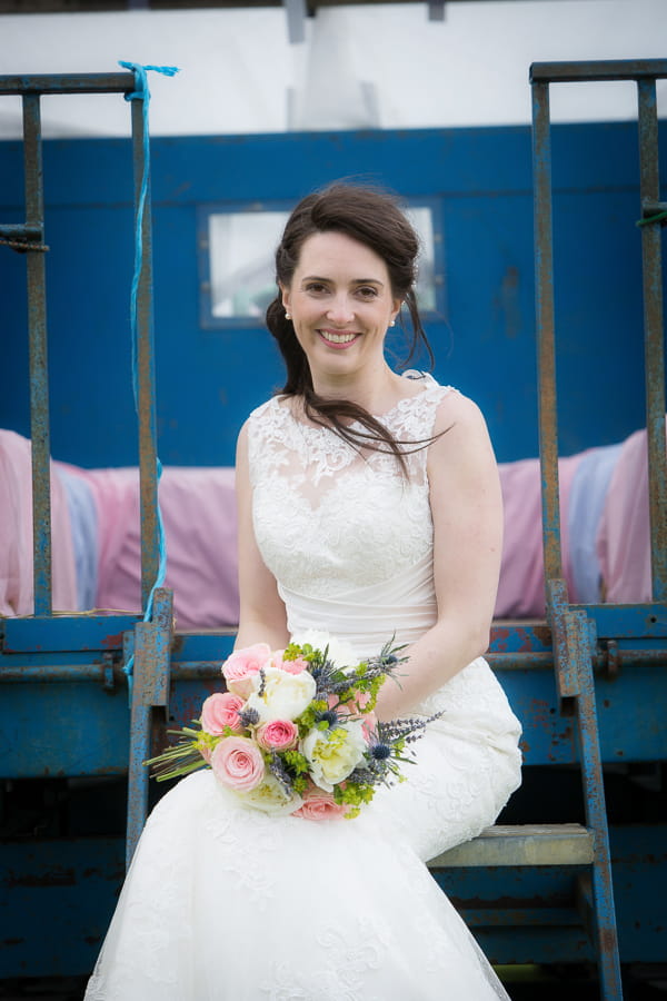 Bride sitting with bouquet