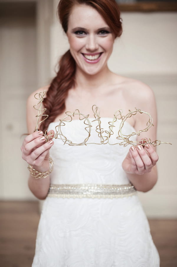 Bride holding wire Love sign