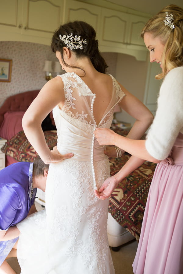 Doing up bride's dress