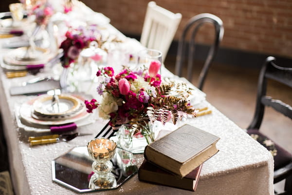 Flowers and books on wedding table