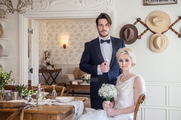 Elegant bride and groom sitting at table