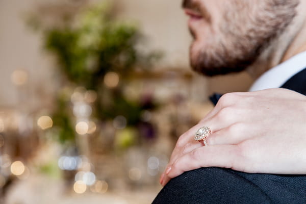 Bride's hand on groom's shoulder