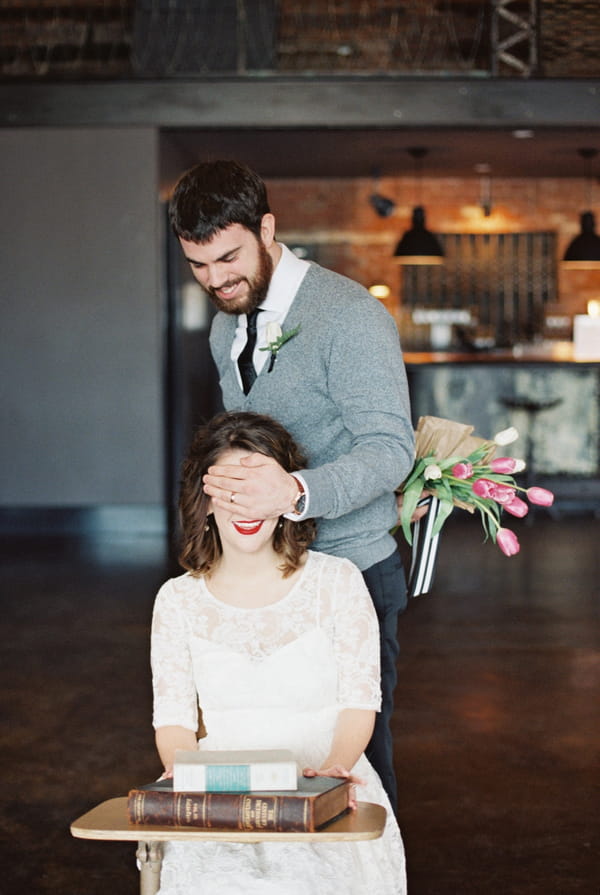 Man covering woman's eyes