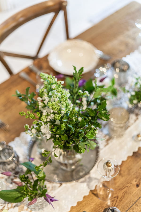 Vase of foliage on table