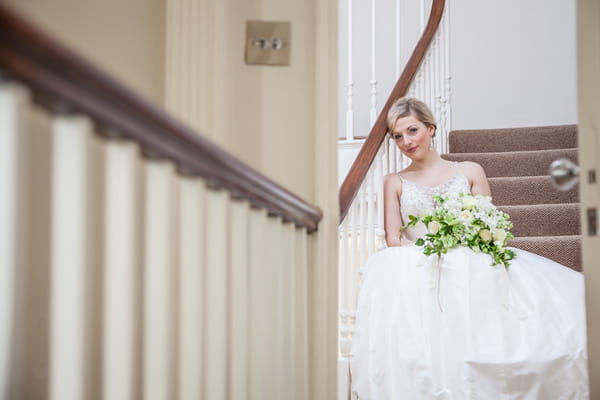 Bride sitting on stairs