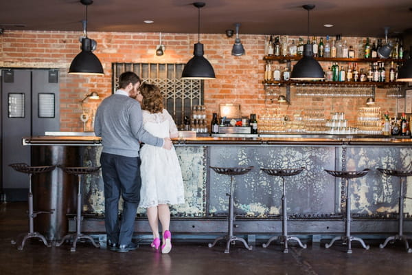 Couple standing at bar