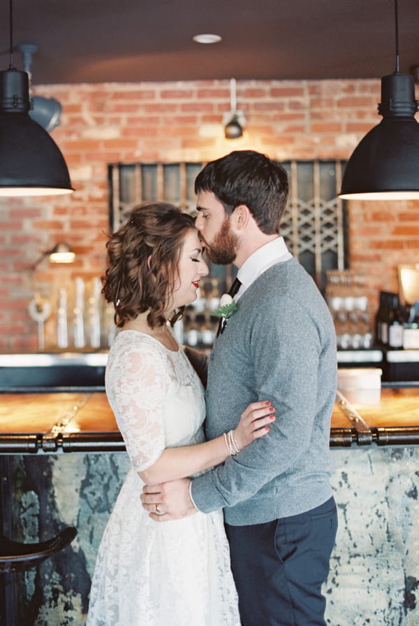 Man kissing woman on head