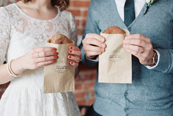 Couple holding donuts