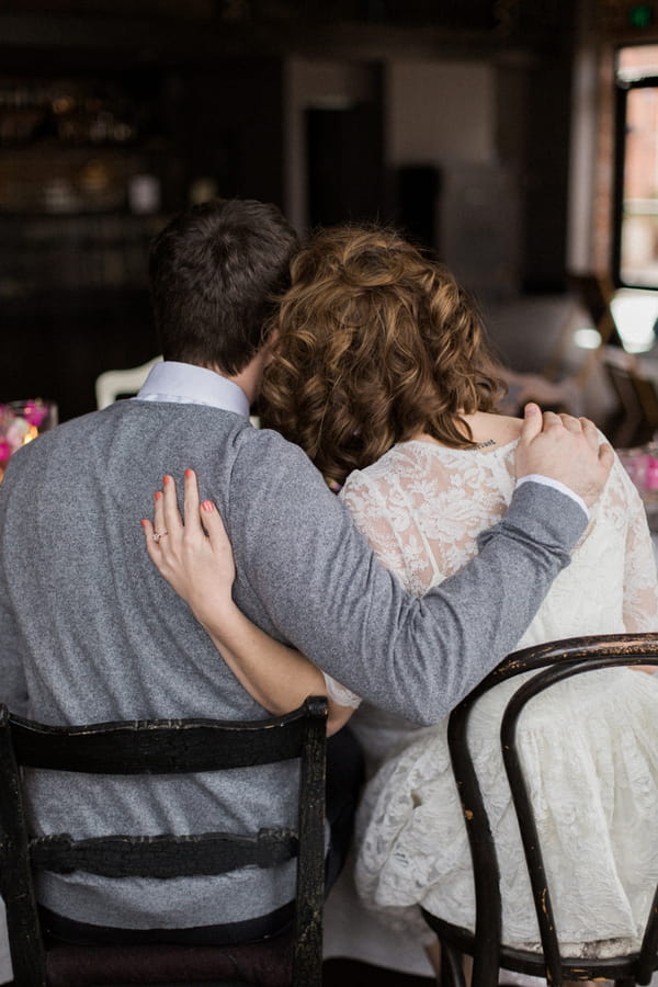 Couple with arms around each other