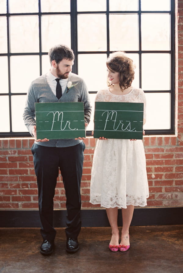 Couple holding mr and mrs chalkboard signs