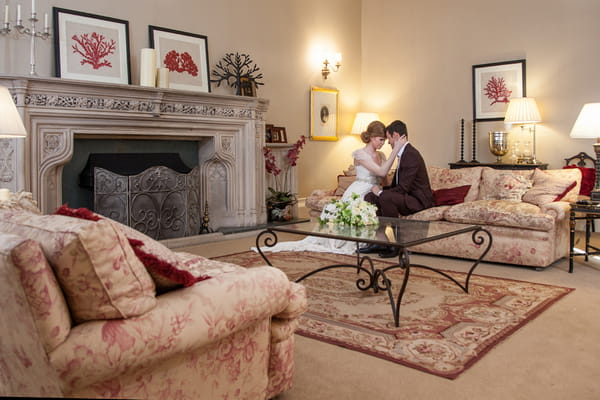 Bride and groom sitting on couch