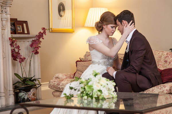 Bride and groom sitting on couch