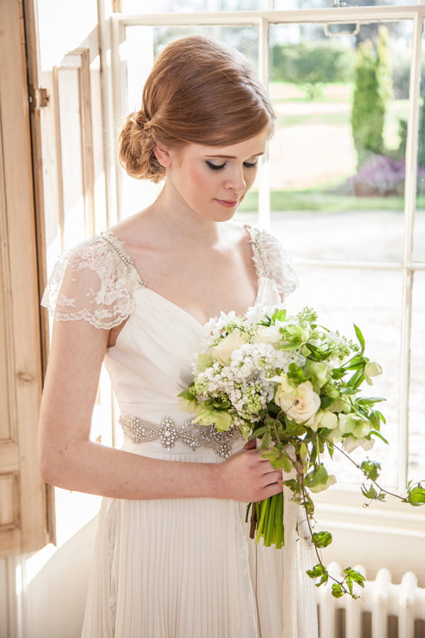 Bride looking down at bouquet