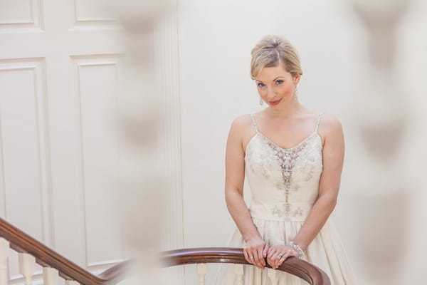 Bride holding onto bannister