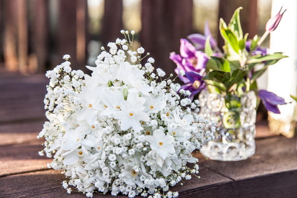 Bridal bouquet and small vase of flowers