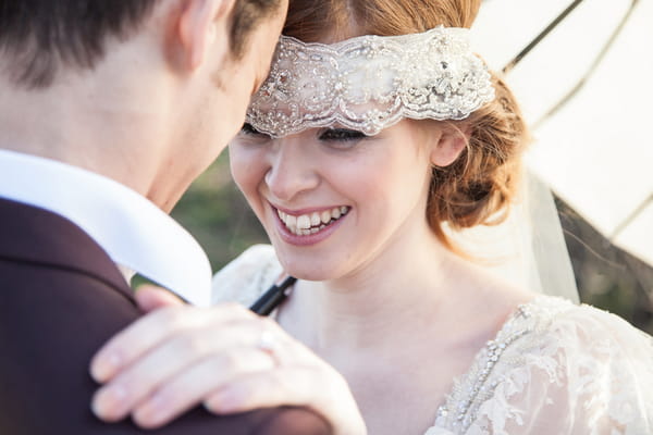 Bride with lace bridal headband smiling