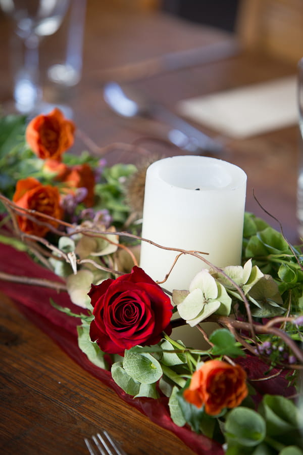 Candle and flowers wedding table centrepiece