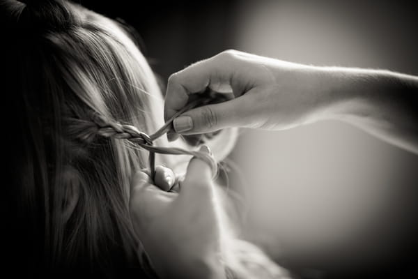 Bride having hair braided