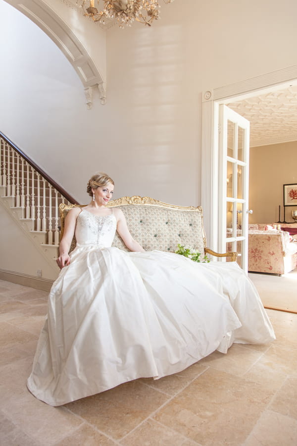 Bride sitting on chaise longue