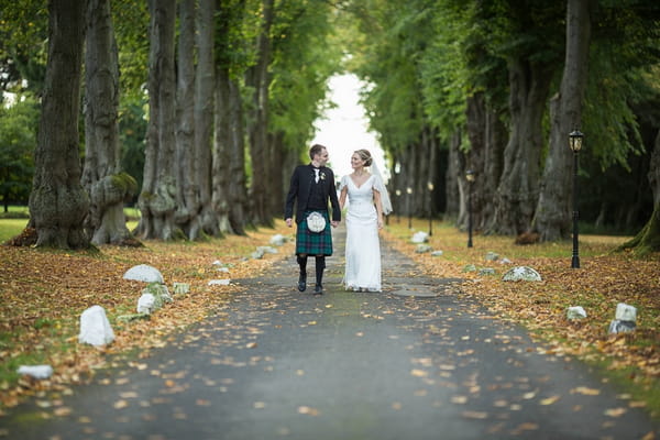 Couple walking on path at Carberry Tower