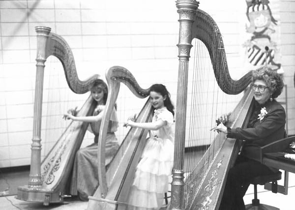 Young Michelle Dalton playing the harp