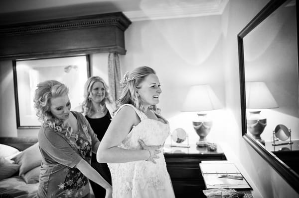 Bride putting dress on