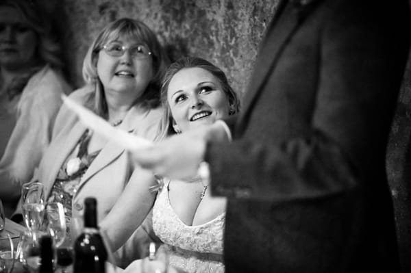 Bride looking up at groom making speech