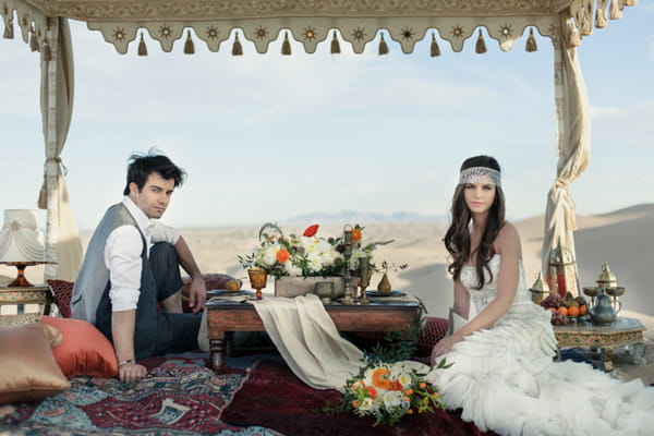 Bride and groom sitting at Moroccan style table