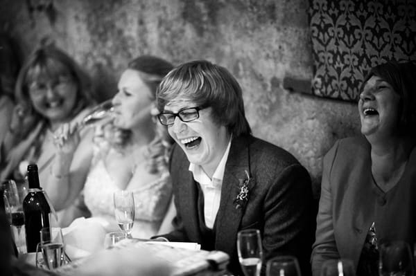 Groom laughing at speech