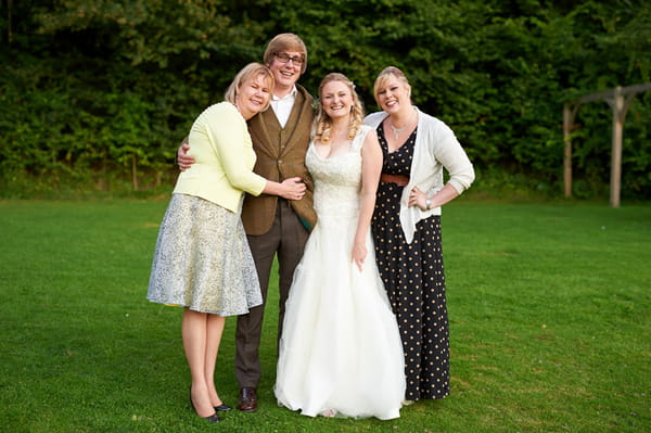 Bride and groom having picture taken with guests