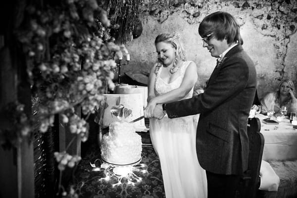 Bride and groom cutting cake