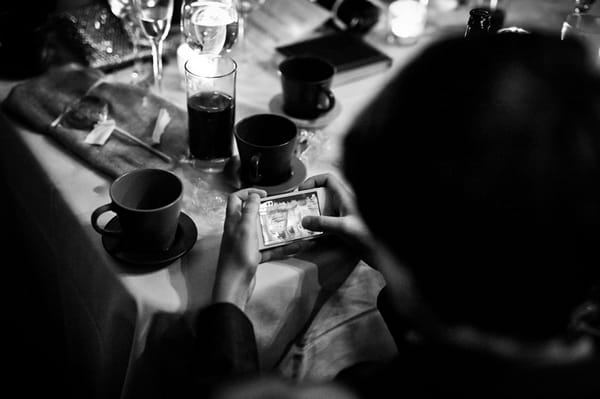 Wedding guest looking at pictures on camera