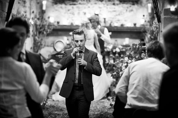 Wedding guest drinking through straw