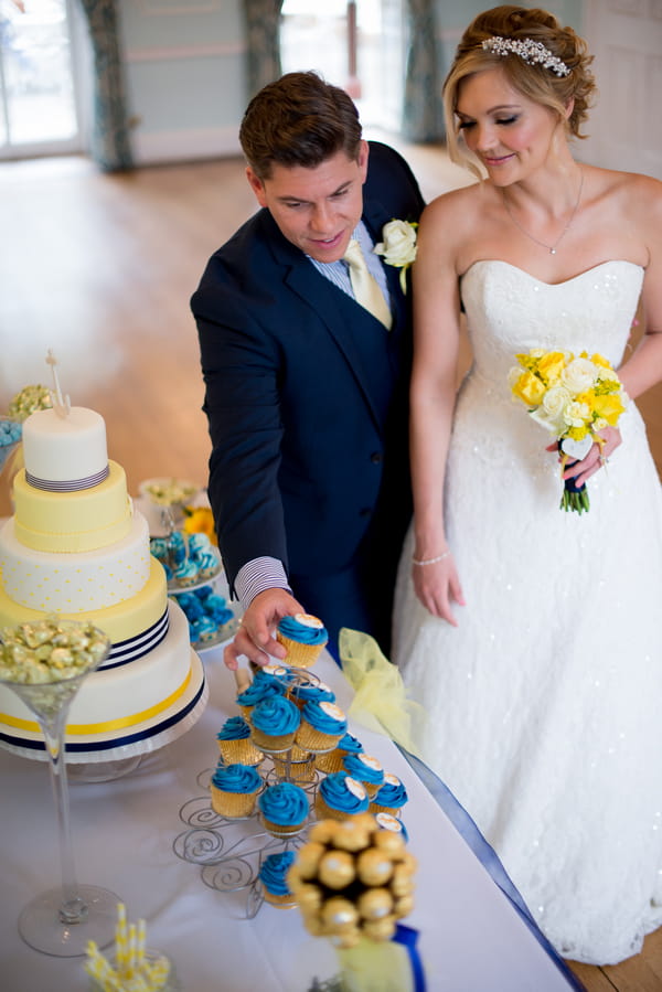 Groom taking cupcake