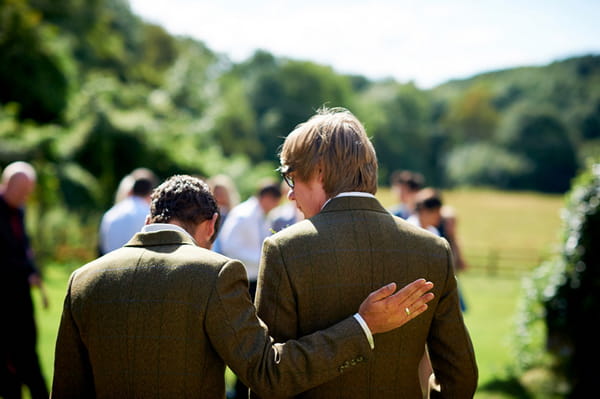 Best man patting groom on back