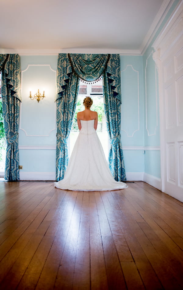 Bride standing at window