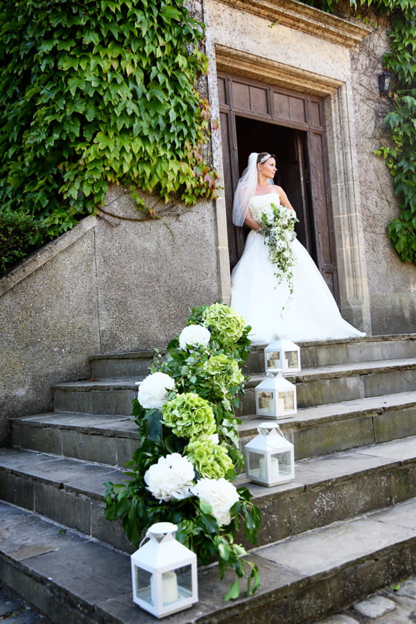 Hurricane lanterns, hydrangea and foliage on steps