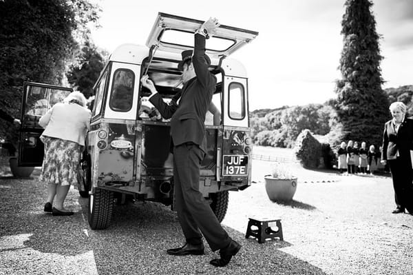 Chauffeur opening back of Land Rover