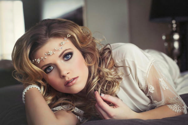 Woman with headband lying on bed - Bridal boudoir shoot