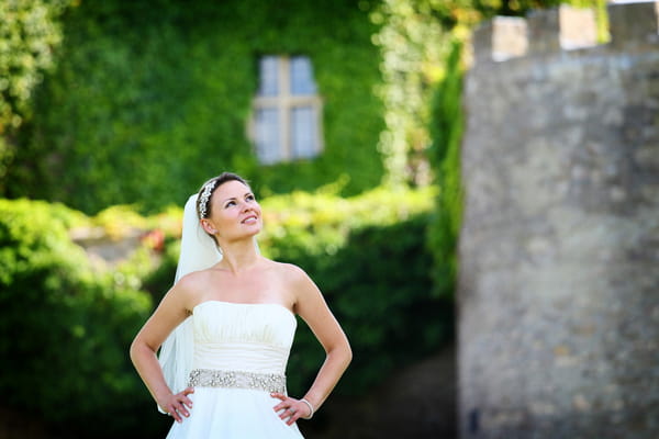 Bride with hands on hips looking up